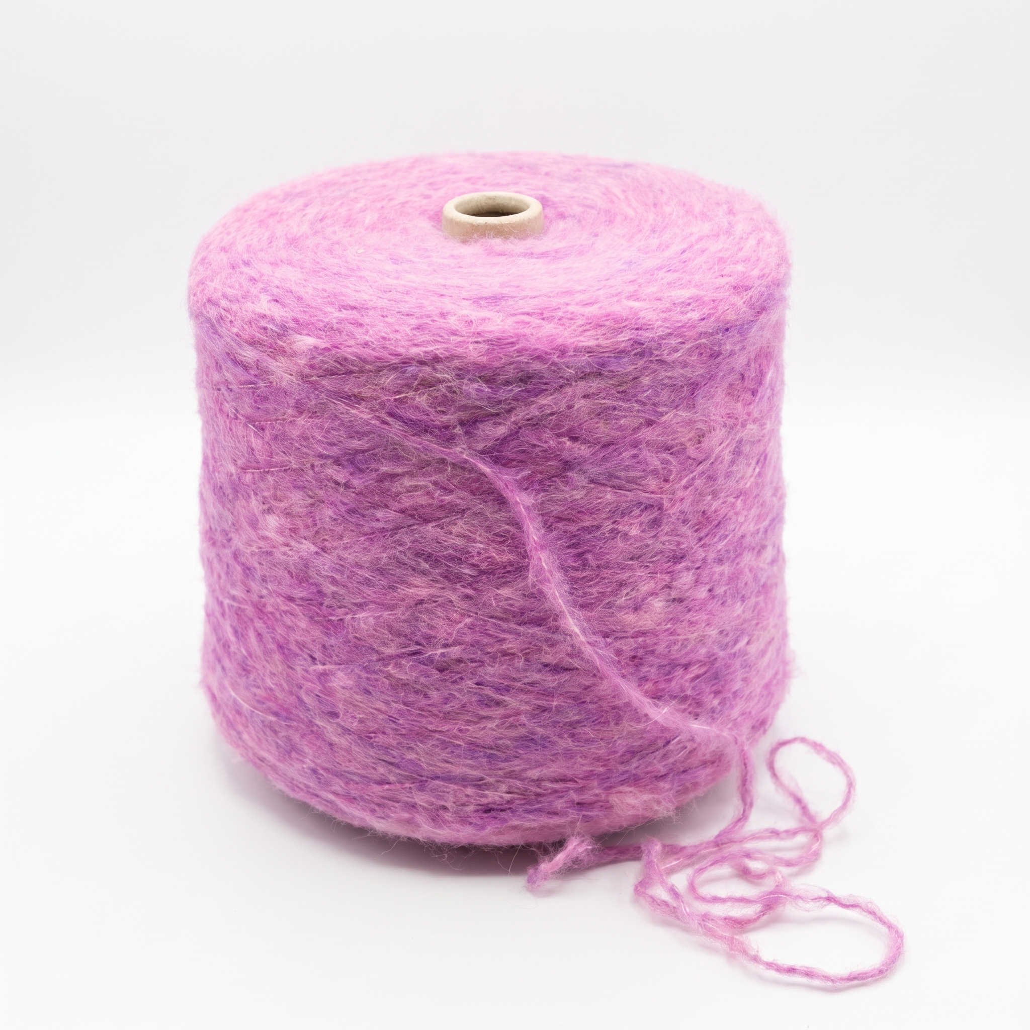 En stor cone med rosa, luddigt garn på en vit bakgrund.