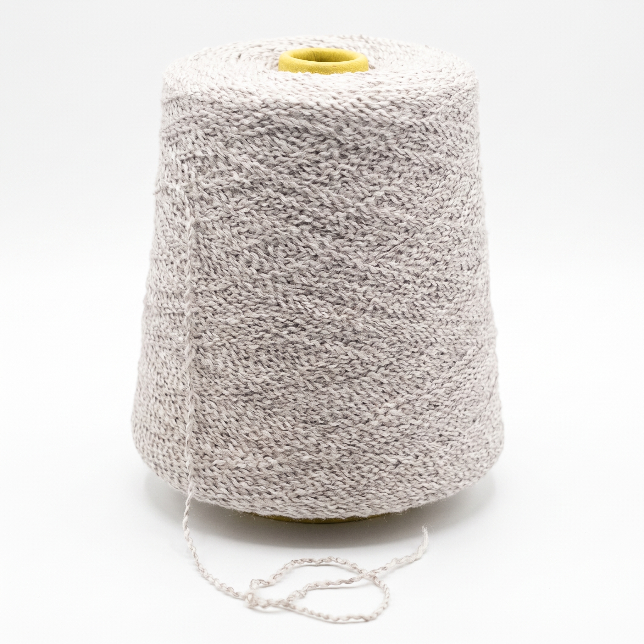 En stor cone med ljust, texturerat garn, med en lös tråd och en gul topp, mot en vit bakgrund.