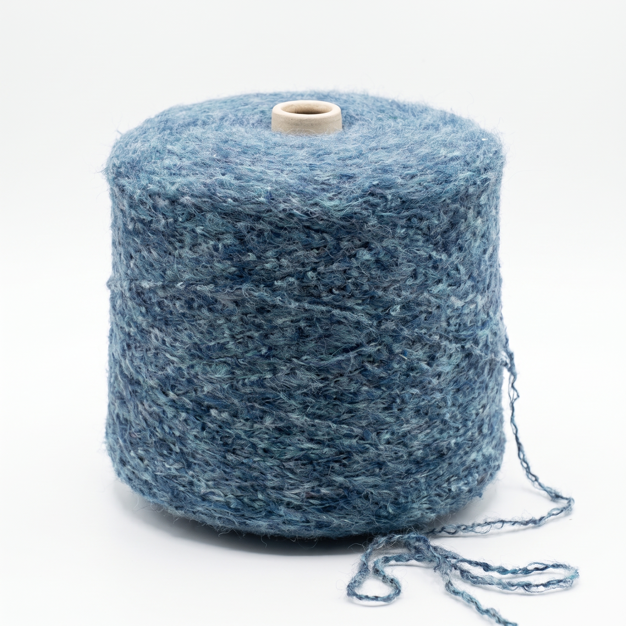 En stor cone med blått, texturerat garn mot en vit bakgrund.